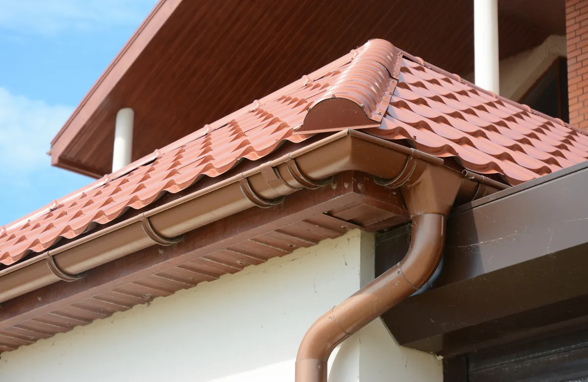 uPVC guttering and downpipe on a tiled roof fitted by JRS Group Ltd in Surrey